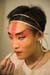 Peking Opera performer applying make up 3